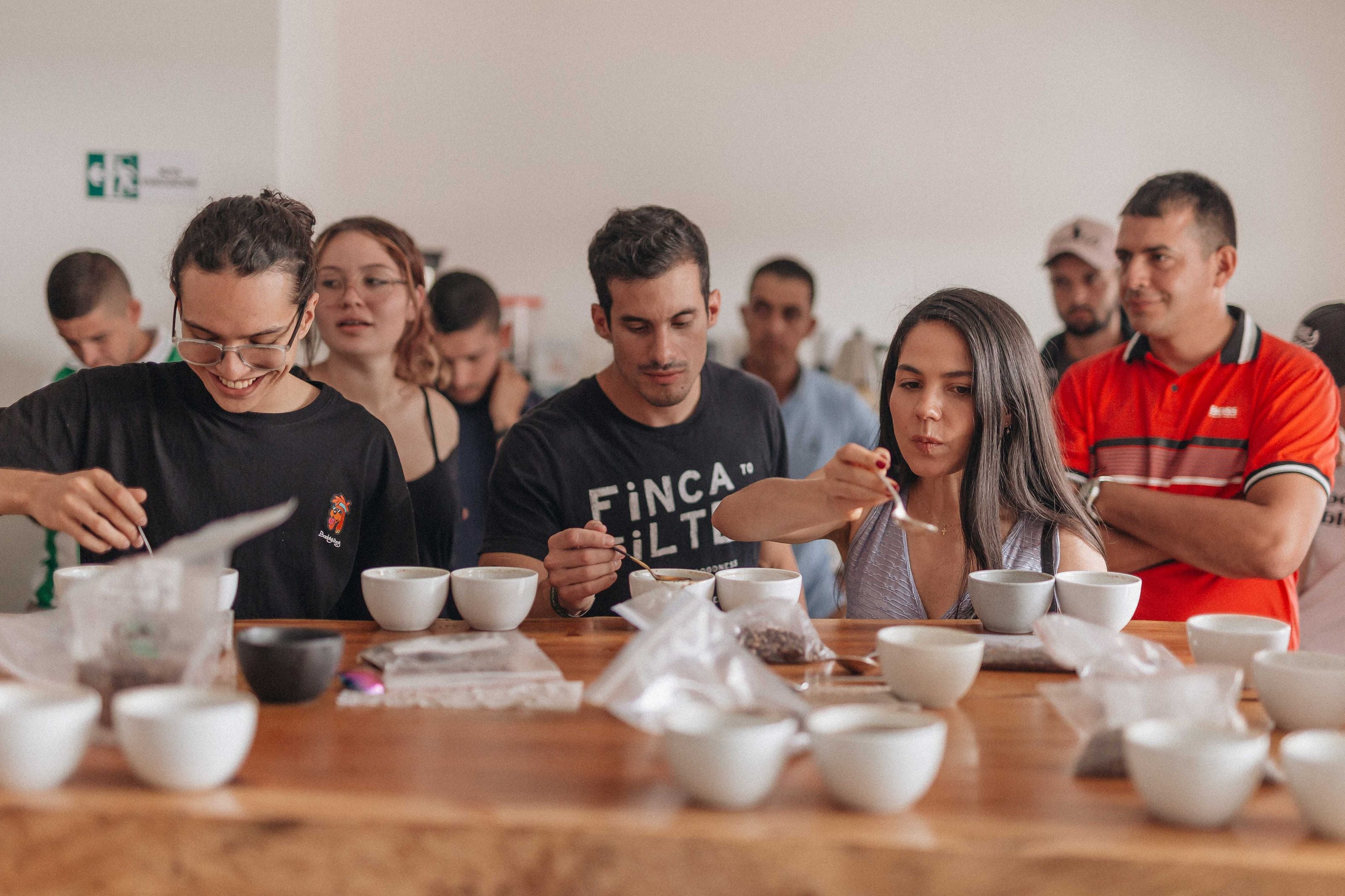 A group of young adults tasting the new holiday coffee blend from Snowy Owl: Heartside Cinnamon
