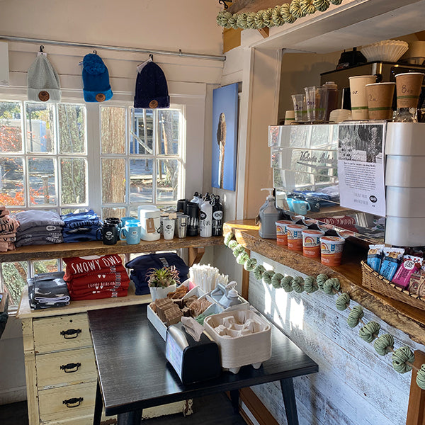 The welcoming service counter at Snowy Owl features fresh pastries, specialty coffee equipment, and a selection of ethically sourced coffee beans, ready for baristas to craft the perfect artisanal drink.