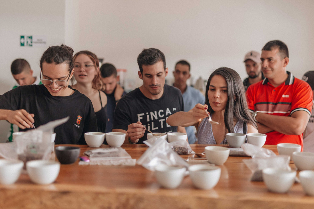A group of young adults tasting the new holiday coffee blend from Snowy Owl: Heartside Cinnamon